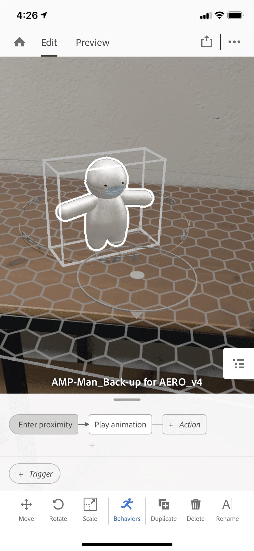 A 3-D model is set on a desk in Adobe Aero's iPhone interface
