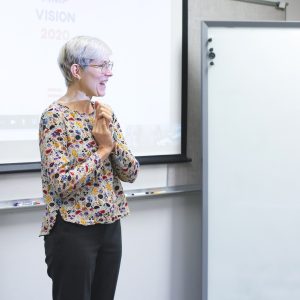 Woman presenting in front of whiteboard