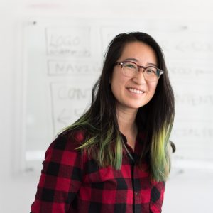 woman smiling in front of whiteboard